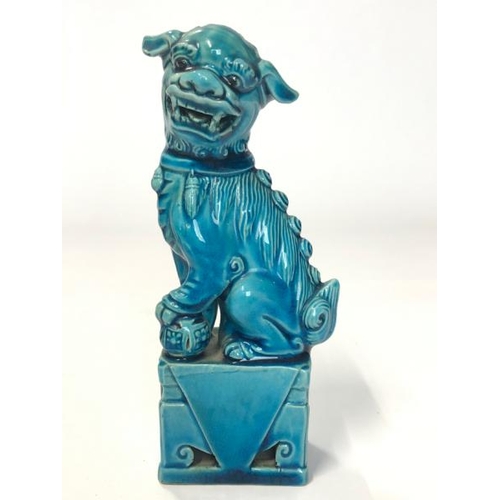 10 - Three figurines, blue glazed Chinese foo dog, 16cm high, laughing Budha, 9cm high and flute player, ... 