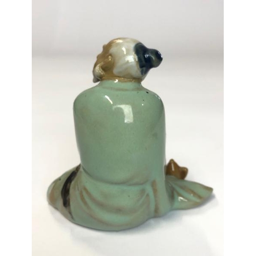 12 - Porcelain glazed figure of an old chinese man drinking tea, 9cm high (Lot subject to VAT) / AN3