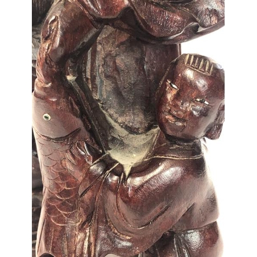 16 - A carved hardwood figure of a fisherman and child, 30cm high / AN3