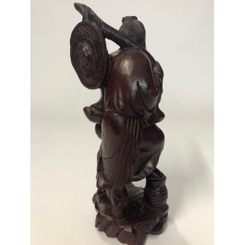 16 - A carved hardwood figure of a fisherman and child, 30cm high / AN3