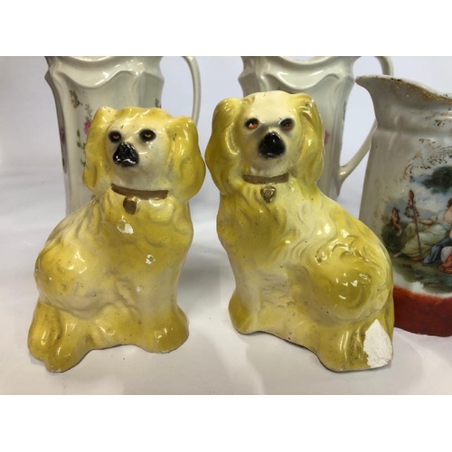 35 - Four decorative ceramic jugs and a pair of porcelain dogs / AN8