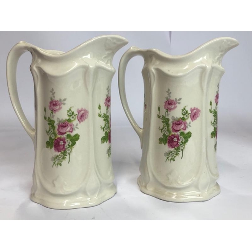 35 - Four decorative ceramic jugs and a pair of porcelain dogs / AN8