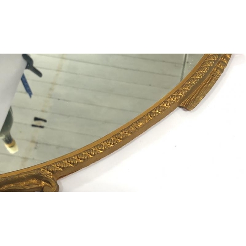 36 - A small oval wall mirror with decorative metal frame, 48cm high