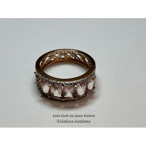 157 - A hallmarked 9ct rose gold ring by QVC with pierced floral design band and set with two rows of sing... 