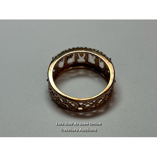 157 - A hallmarked 9ct rose gold ring by QVC with pierced floral design band and set with two rows of sing... 