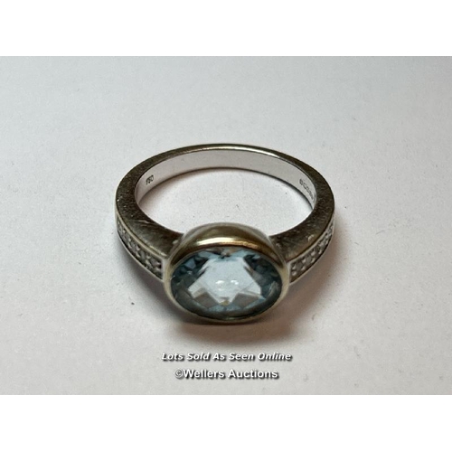 158 - An aquamarine and diamond ring in hallmarked 18ct gold. The checquer board cut oval aquamarine measu... 