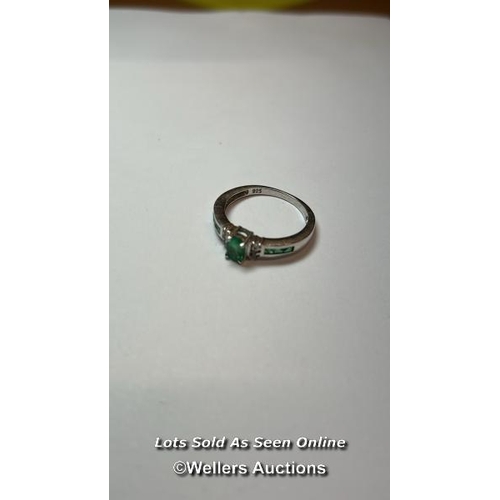 166 - Emerald and silver ring. Ring size, O. (one stone missing) / SF