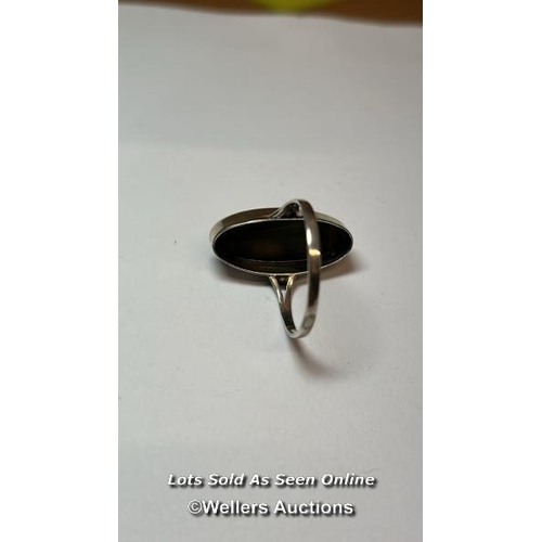 169 - An opel ring in white metal stamped 925 for silver, ring size Q, and a chrysoberyl ring in white met... 