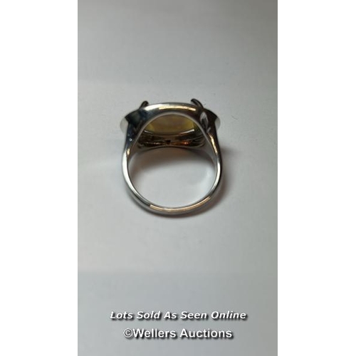 169 - An opel ring in white metal stamped 925 for silver, ring size Q, and a chrysoberyl ring in white met... 