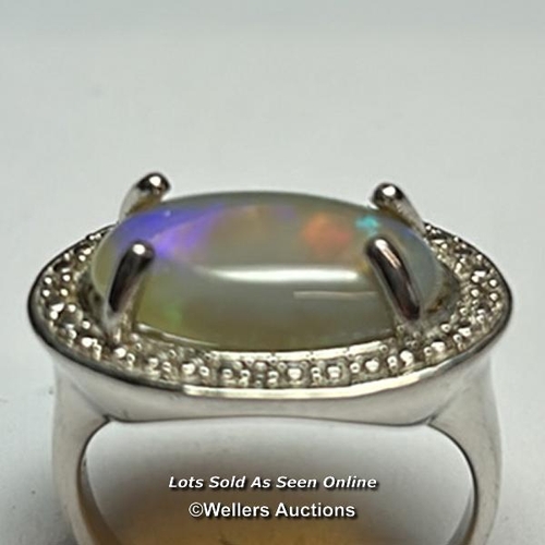 169 - An opel ring in white metal stamped 925 for silver, ring size Q, and a chrysoberyl ring in white met... 