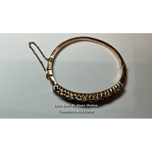 173 - Antique 9ct gold hinged bangle set with garents and rose cut diamonds, with safety chain. Gross weig... 