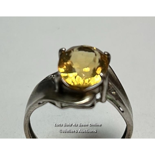 176 - Hallmarked silver ring set with an ovel citrine and cubic zirconia detail on shoulders. Ring size, O... 