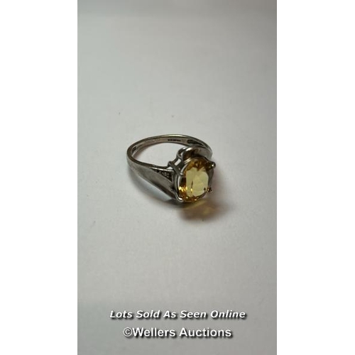 176 - Hallmarked silver ring set with an ovel citrine and cubic zirconia detail on shoulders. Ring size, O... 