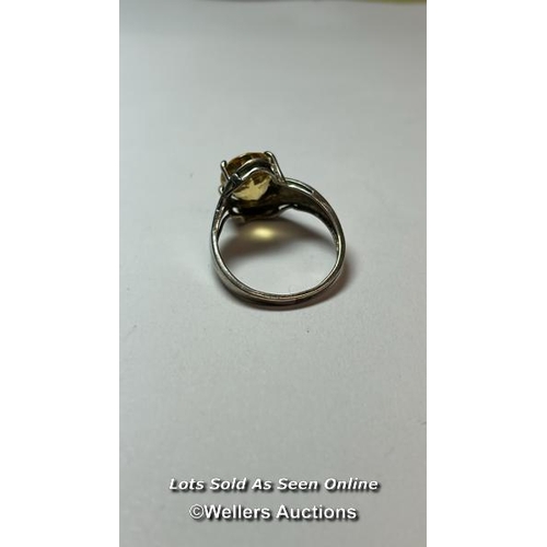 176 - Hallmarked silver ring set with an ovel citrine and cubic zirconia detail on shoulders. Ring size, O... 