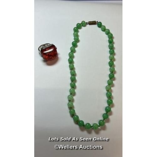 185 - Green glass bead necklace, string knotted to base metal barrel clasp. Length 40cm, with a plastic an... 