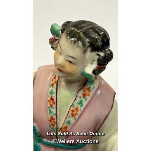 52 - a group of three Japanese famille rose porcelain figures on a carved wooden base, 16cm high / AN9