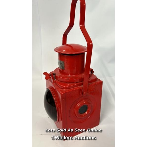 80 - A nicely restored red railway London Transport rear lamp complete with reservoir and burner, 46cm hi... 