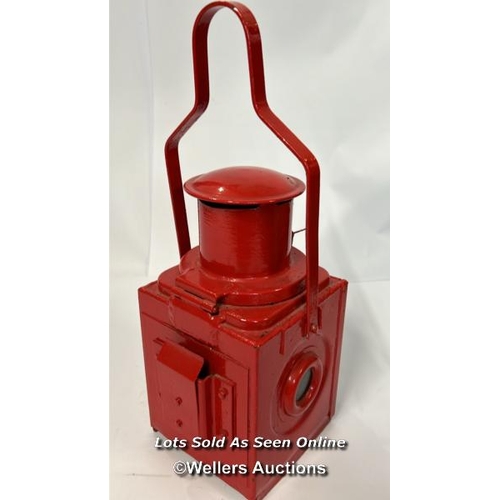 80 - A nicely restored red railway London Transport rear lamp complete with reservoir and burner, 46cm hi... 