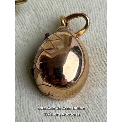 202 - A Faberge style egg pendant with hatching diamond encrusted chick, measuring 20mm x 12mm, the loop w... 