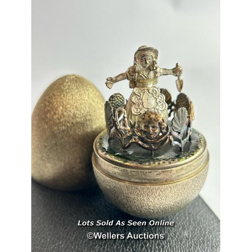 209 - A hallmarked silver gilt egg Stuart Devlin, London 1973, nursery rhyme collection. Opening to reveal... 