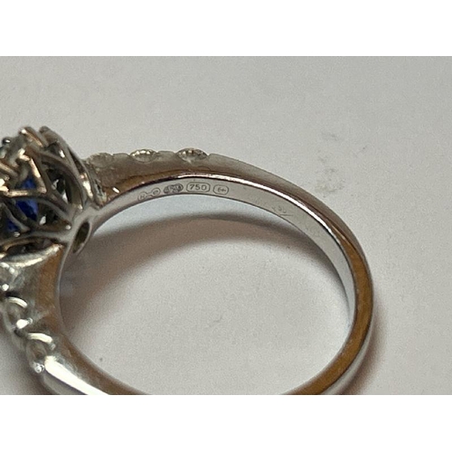 222 - A saphire and diamond cluster ring with diamond set shoulders, one diamond missing, in hallmarked 18... 