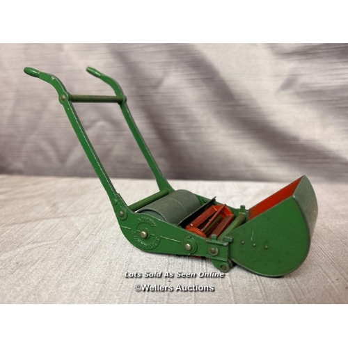 136 - DINKY SUPERTOYS GARDEN PUSHALONG LAWN MOWER WITH ROLLER, TOGETHER WITH A DINKY DIE CAST WHEELBARROW ... 