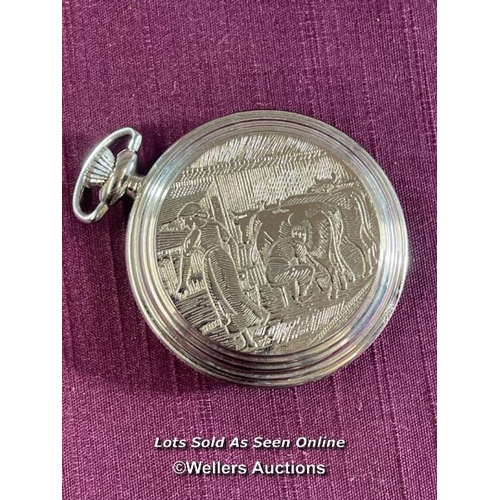 416 - CARVEL TRAVEL WATCH, DEPICTING FARMER MILKING THE COW, HALLMARKED CASE