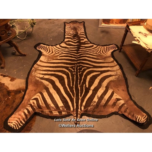 543 - CIRCA 1910 GREVY'S BROWN AND WHITE ZEBRA SKIN RUG, 250 X 182CM