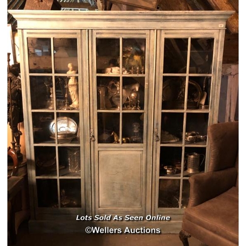 558 - CIRCA 1900 THREE DOOR GLAZED BOOKCASE, ANTIQUE PAINT FINISH, FOUR GLASS PANELS MISSING, 185 X 32 X 2... 