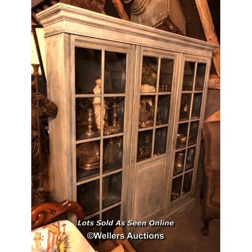 558 - CIRCA 1900 THREE DOOR GLAZED BOOKCASE, ANTIQUE PAINT FINISH, FOUR GLASS PANELS MISSING, 185 X 32 X 2... 