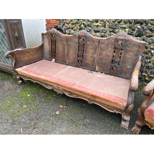 172 - ORNATELY CARVED DOUBLE CANED BERGERE LOUNGE SUITE, IN NEED OF SOME RESTORATION, THREE SEATER SECTION... 