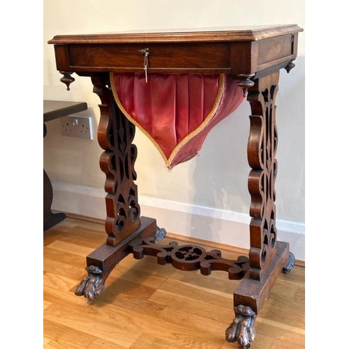 159 - Antique walnut sewing table with sectional interior, clawed feet on casters and working lock with ke... 