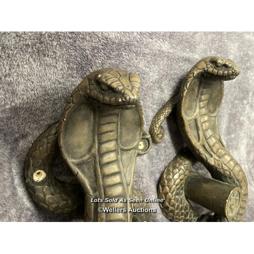 201 - A pair of plaster bronze effect cobra door handles, 46cm high