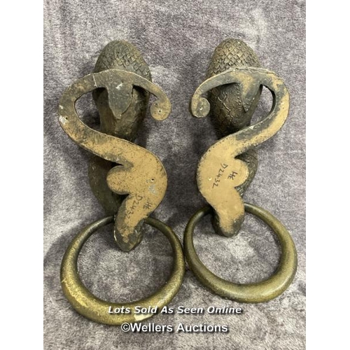 201 - A pair of plaster bronze effect cobra door handles, 46cm high