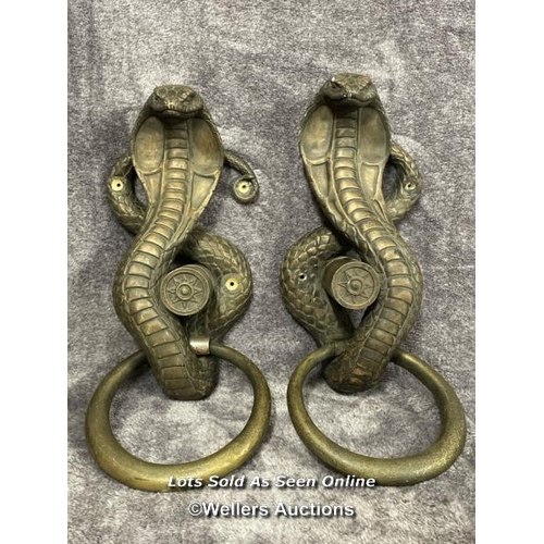 202 - A pair of plaster bronze effect cobra door handles, 46cm high