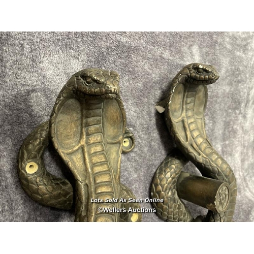 202 - A pair of plaster bronze effect cobra door handles, 46cm high