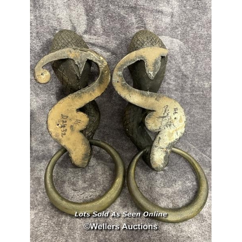 202 - A pair of plaster bronze effect cobra door handles, 46cm high