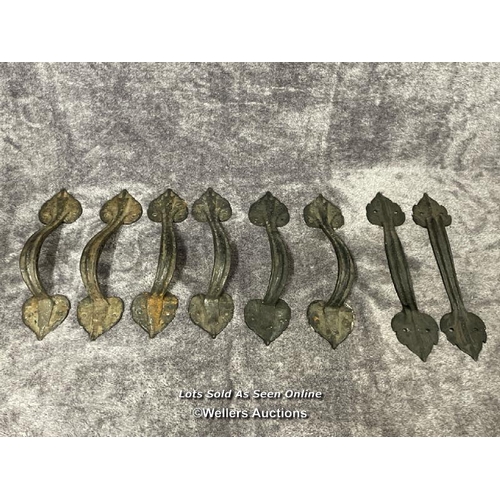 204 - Four pairs of wrought iron door pull handles, in leaf design, longest is 34cm