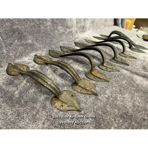 204 - Four pairs of wrought iron door pull handles, in leaf design, longest is 34cm