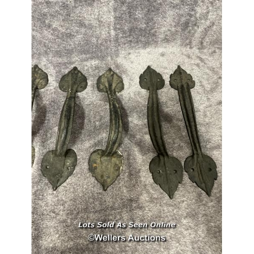 204 - Four pairs of wrought iron door pull handles, in leaf design, longest is 34cm