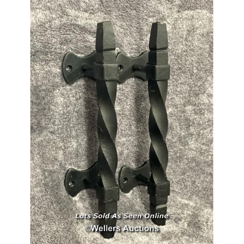 206 - A pair of iron door pull handles in twist design, 28cm long