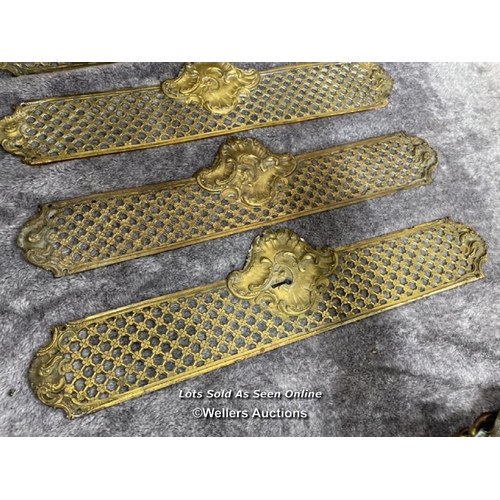 211 - Four brass door handle backings with floral centrepiece and edging, 47cm long x 11.5cm wide