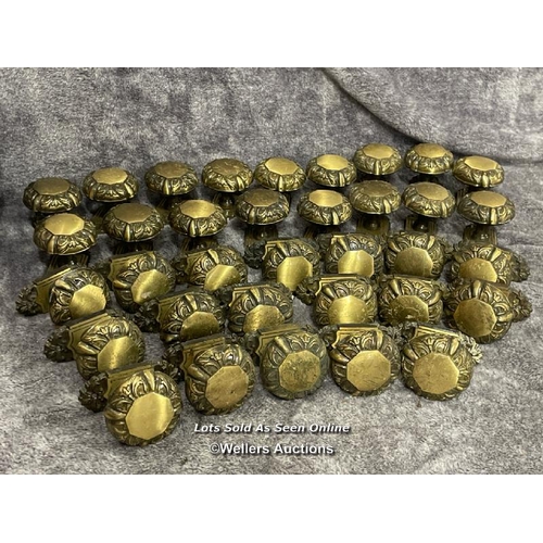 221 - Thirty-five brass door handles with octagonal centrepiece surrounded by floral design edging, 5.5cm ... 