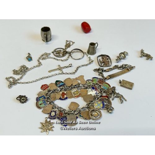 333 - Silver charm bracelet with thirty-eight mostly souvenir charms, along with a silver chain and assort... 