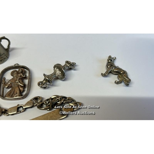 333 - Silver charm bracelet with thirty-eight mostly souvenir charms, along with a silver chain and assort... 