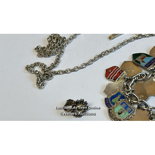 333 - Silver charm bracelet with thirty-eight mostly souvenir charms, along with a silver chain and assort... 