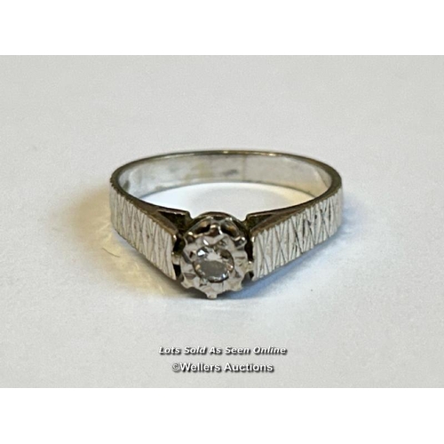 339 - A hallmarked 18ct white gold ring set with a solitaire diamond in an illusion setting with textured ... 