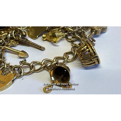 332 - A hallmarked 9ct gold bracelet supporting twenty 9ct gold charms, gross weight 47.07g / SF