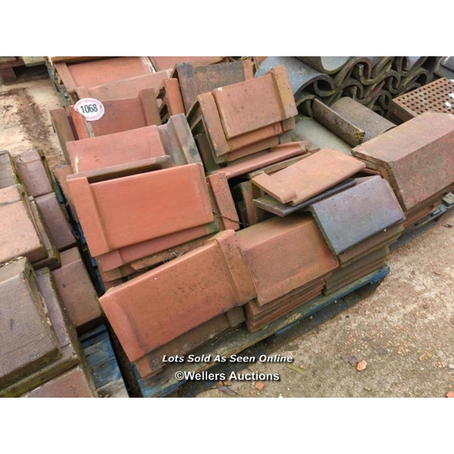 1068 - APPROX X36 ANGLED RED RIDGE ROOF TILES, LARGEST 38CM (L)