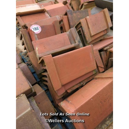 1068 - APPROX X36 ANGLED RED RIDGE ROOF TILES, LARGEST 38CM (L)